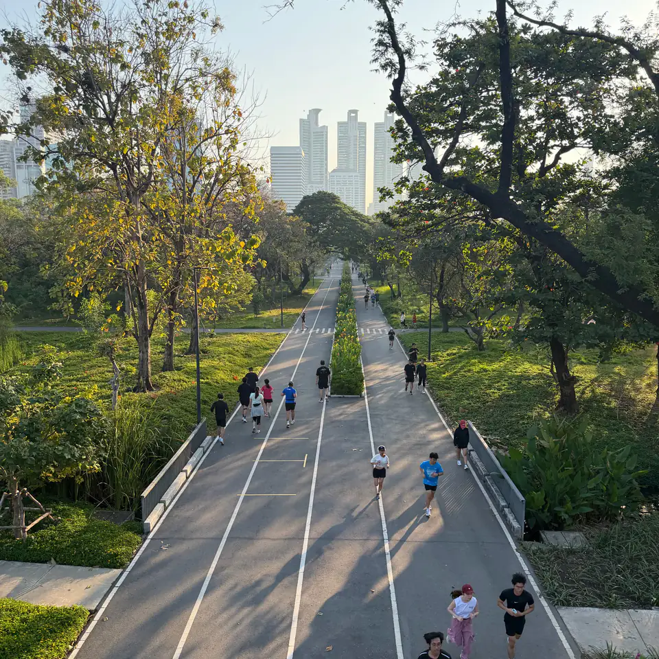 Runners on the path at Benjakitti Park, Bangkok, at golden hour